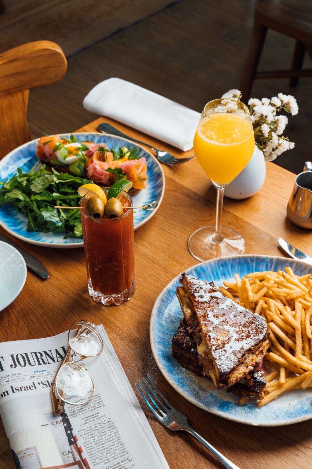 Plate setting with salad, sandwich, bloody mary, and mimosa