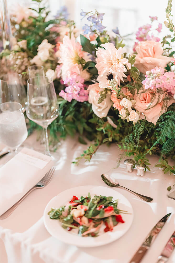 Table setting with flowers and salad