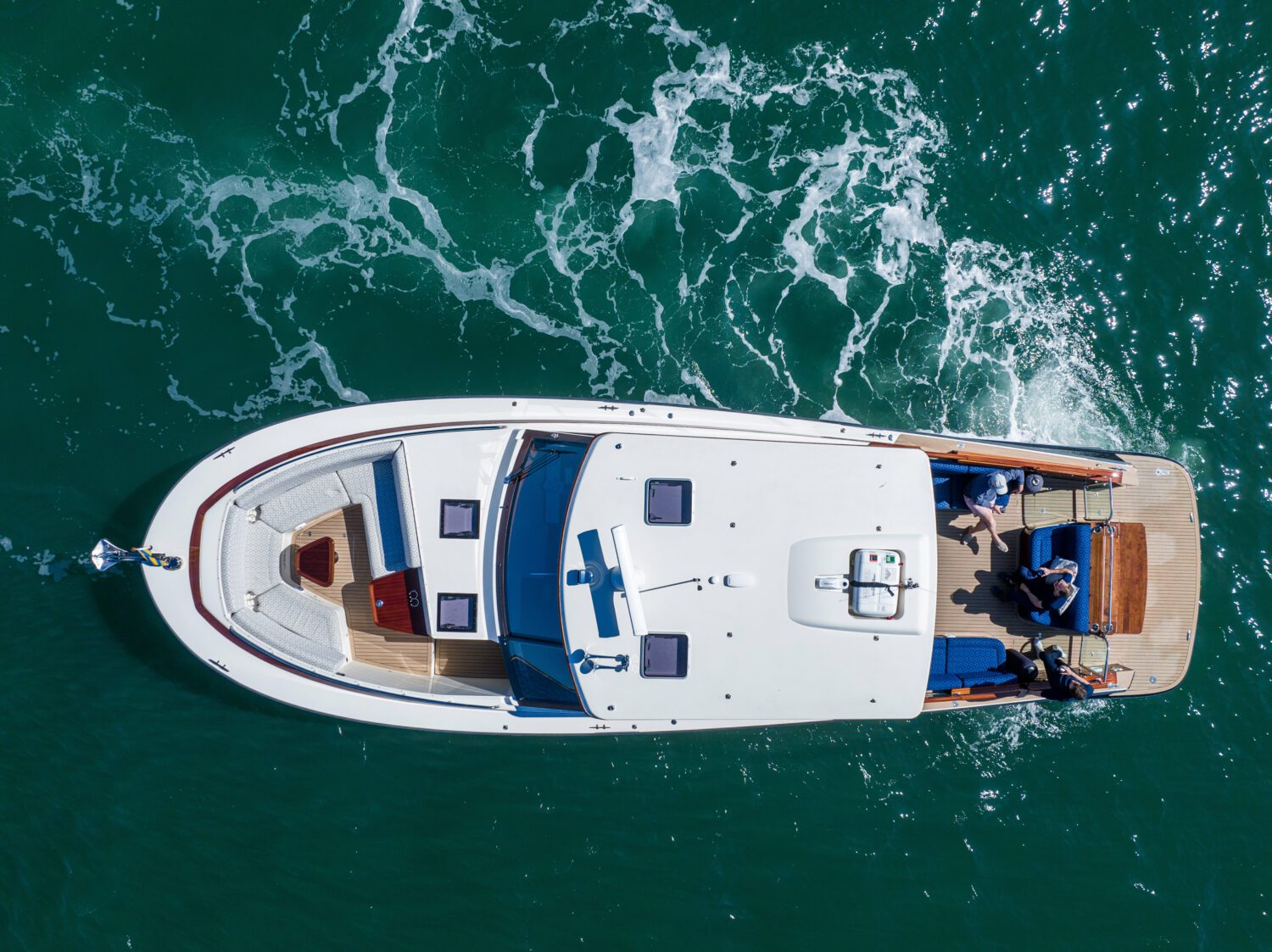 Exterior image of people hanging out on a boat on the water